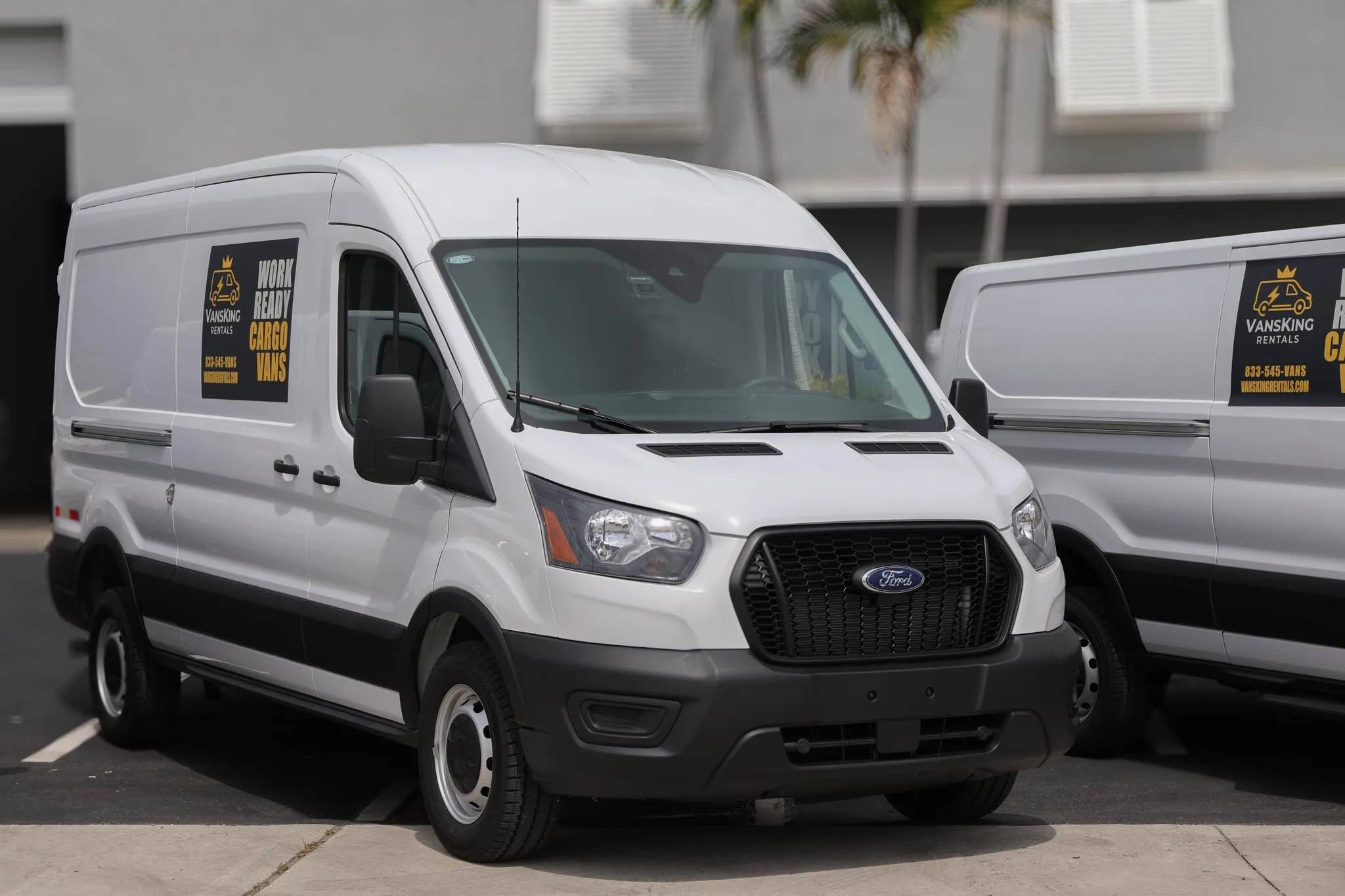 VansKing cargo van being delivered to a job site, with the driver handing over the keys