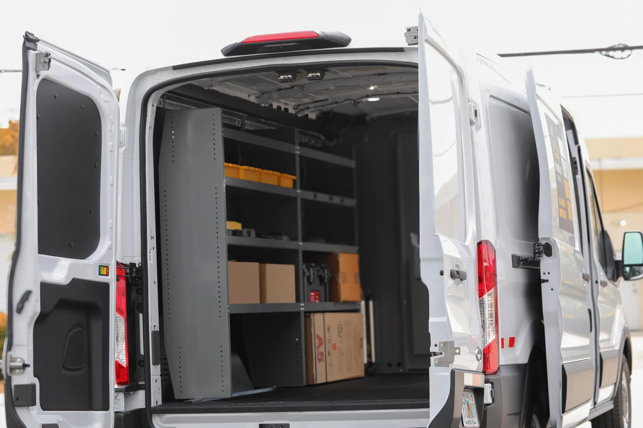 Close-up of the floor and wall protection installed in a VansKing cargo van, with equipment loaded