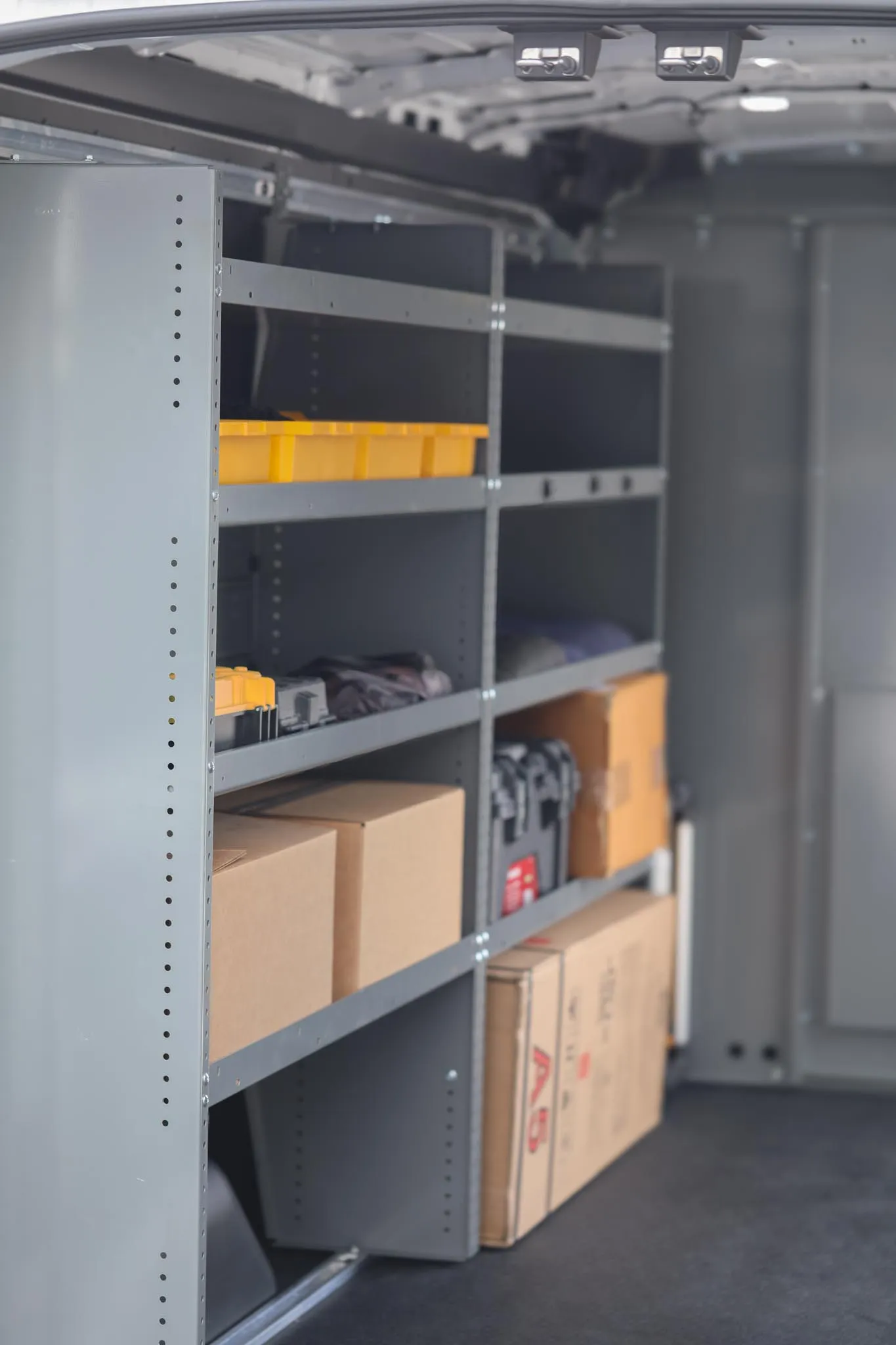 Interior of the Mercedes-Benz Sprinter 2500 high roof cargo van seen from the rear doors, showing shelving, wall protection and LED lighting