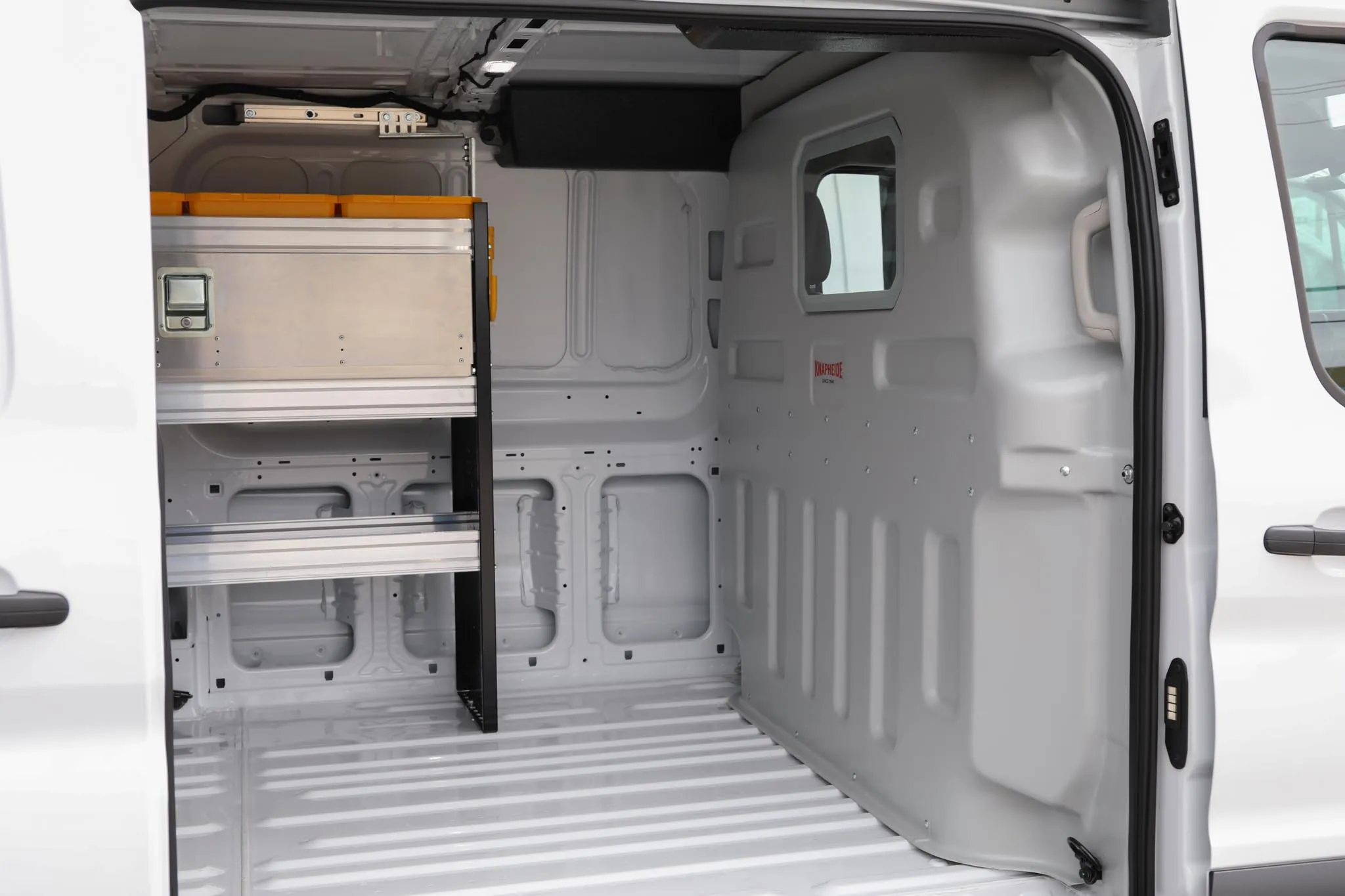 Interior of the Ford Transit 250 low roof cargo van showing shelving and wall protection