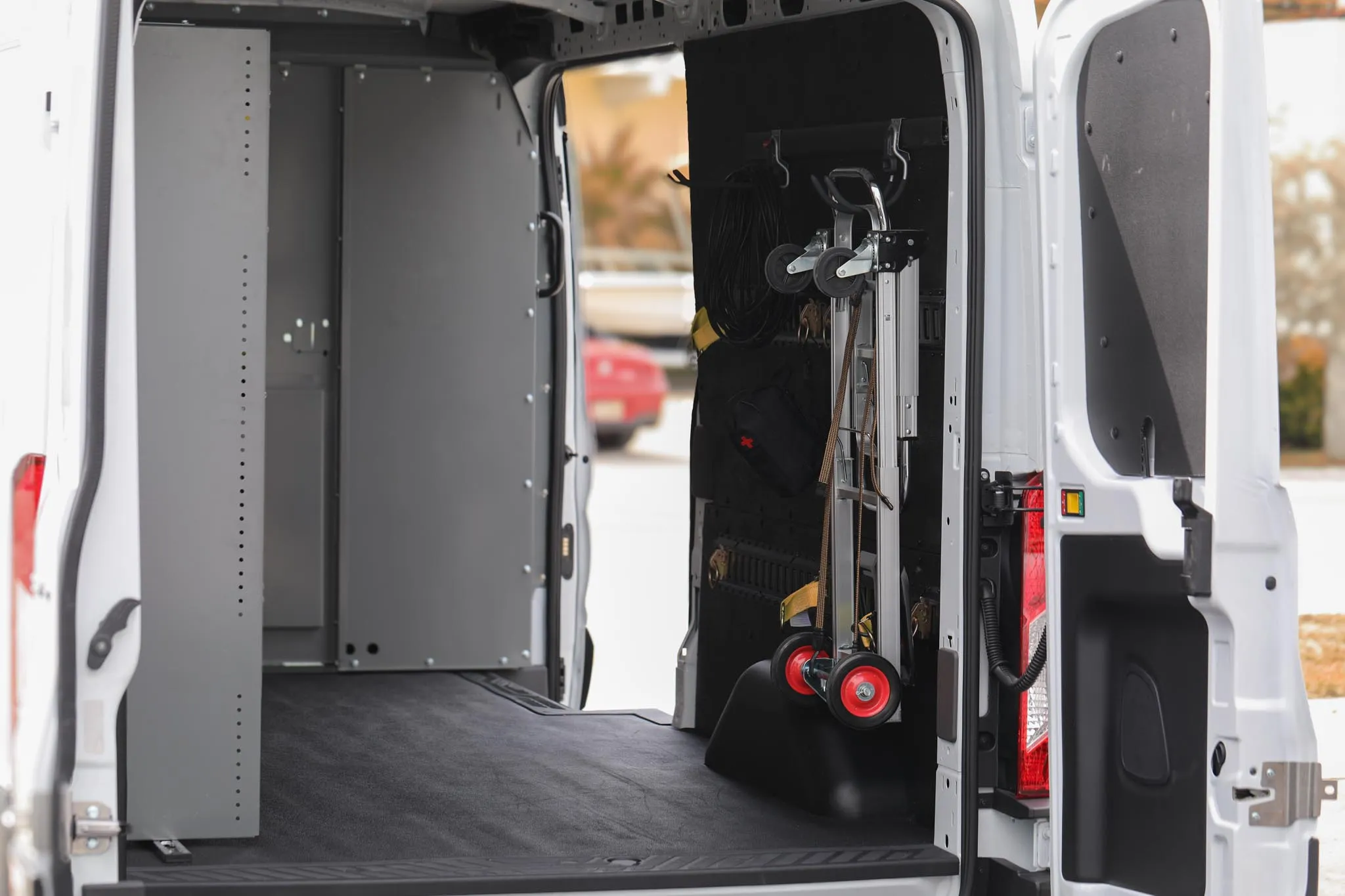 Interior of the Ford Transit 250 medium roof cargo van showing shelving, cargo management and LED lighting