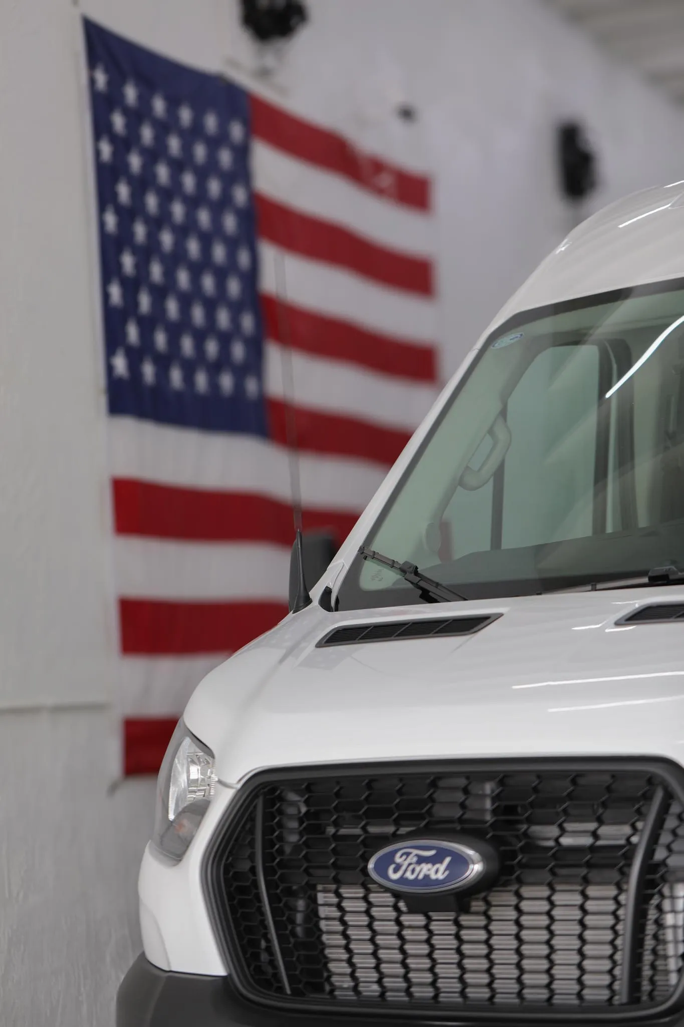 Side door of the Ford Transit 250 medium roof open, showing the floor and wall protection